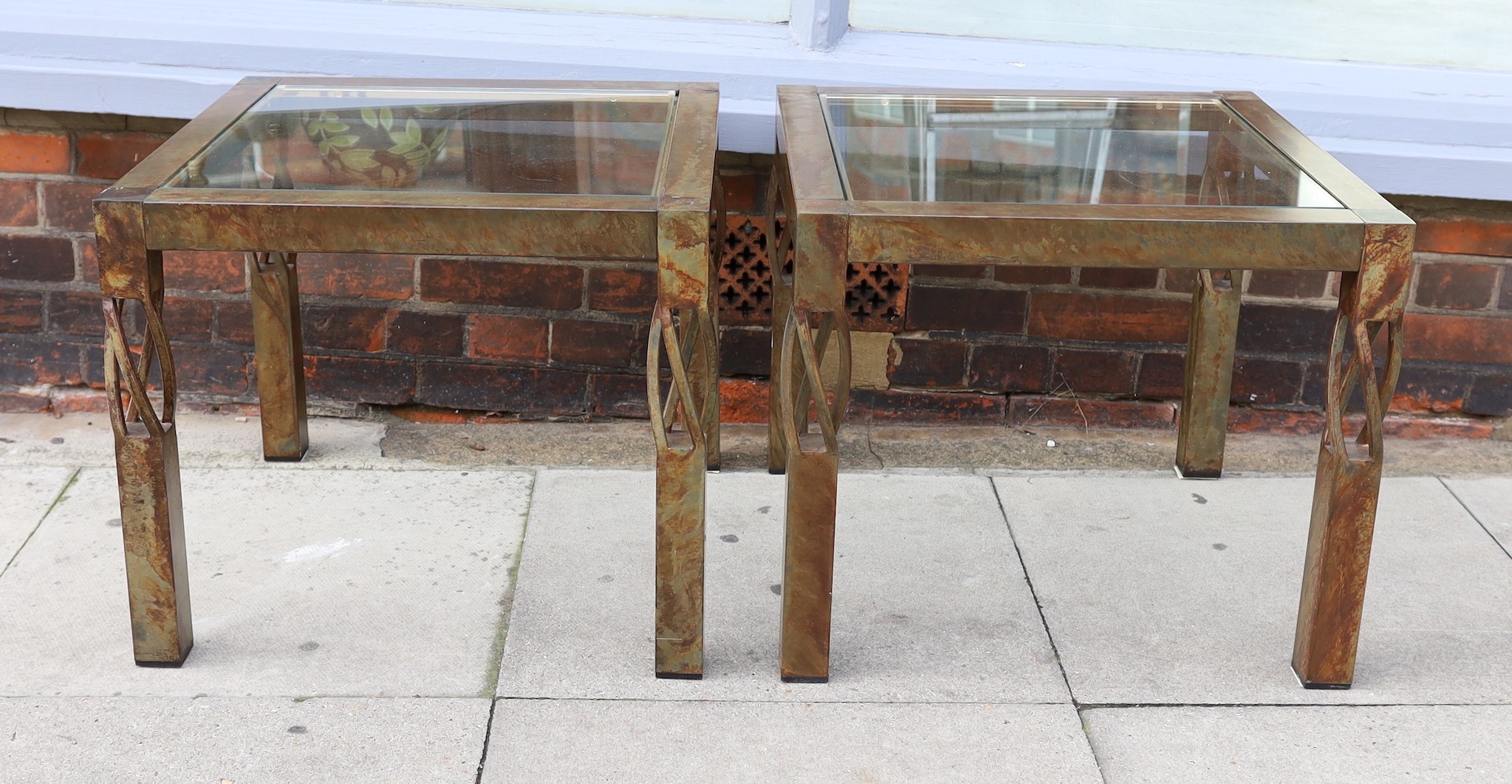 A pair of contemporary bronze metal and glass occasional tables, width 60cm. height 51cm
